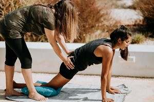 person helping another person stretch