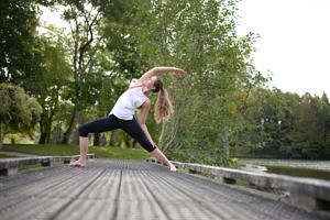 Women performing yoga on a bridge