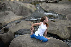 Woman doing yoga by a river | Body Revolution Tauranga