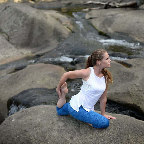 Woman doing yoga by a river | Body Revolution Tauranga