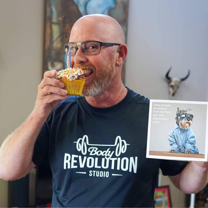 Man eating birthday muffin